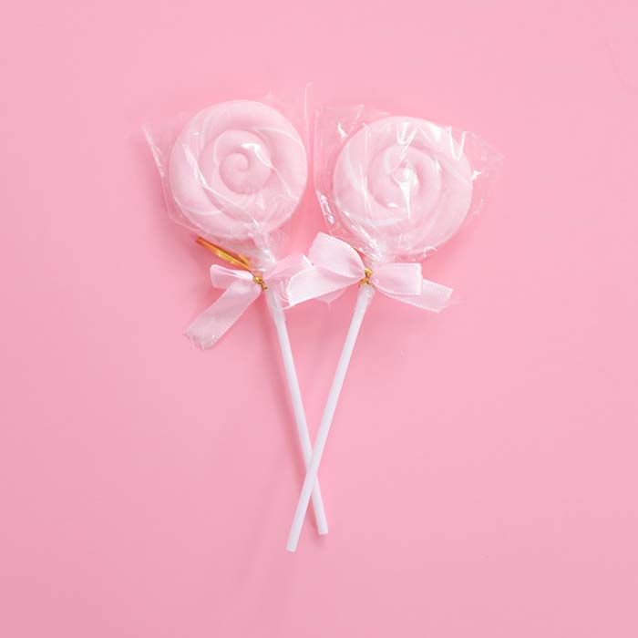 pink lollipops against a pink background